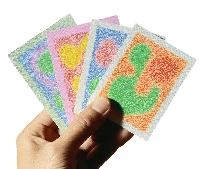 Hand holding four colorful cards with abstract shapes in orange, blue, pink, and green backgrounds.