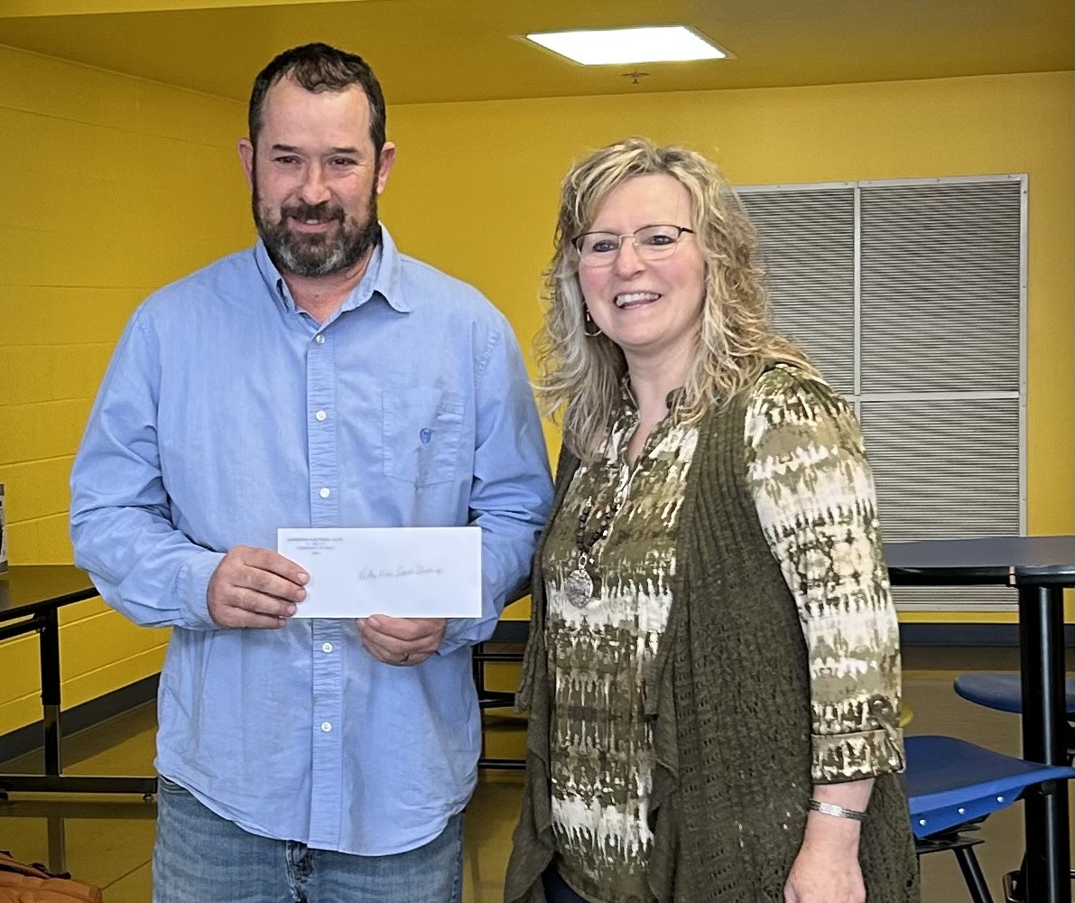 Caliem Morris, VVHS Agriculture Instructor, is presented with a check through a federal grant to pay for students' courses in the pre apprenticeship program.
