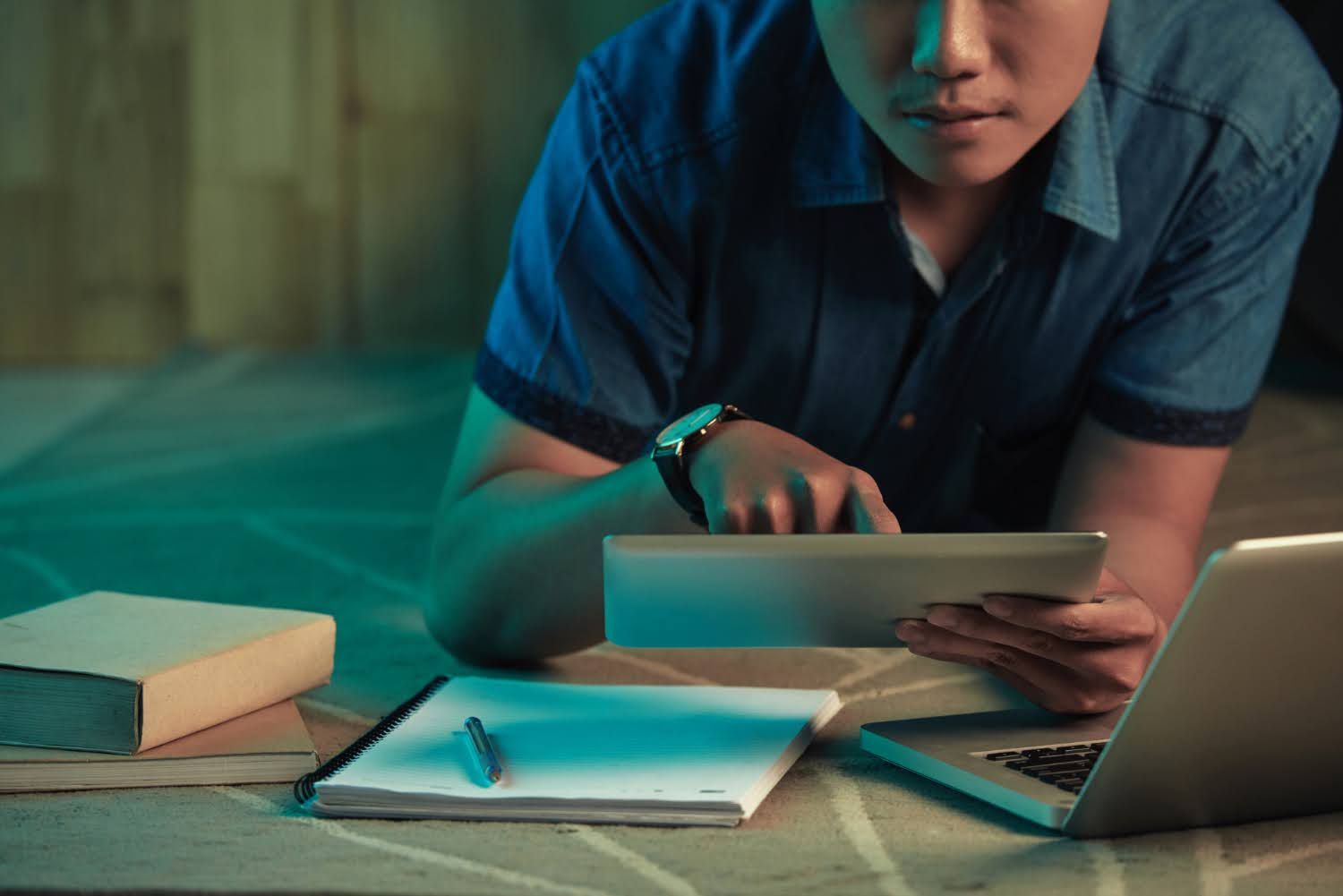An employee taking training on multiple devices.
