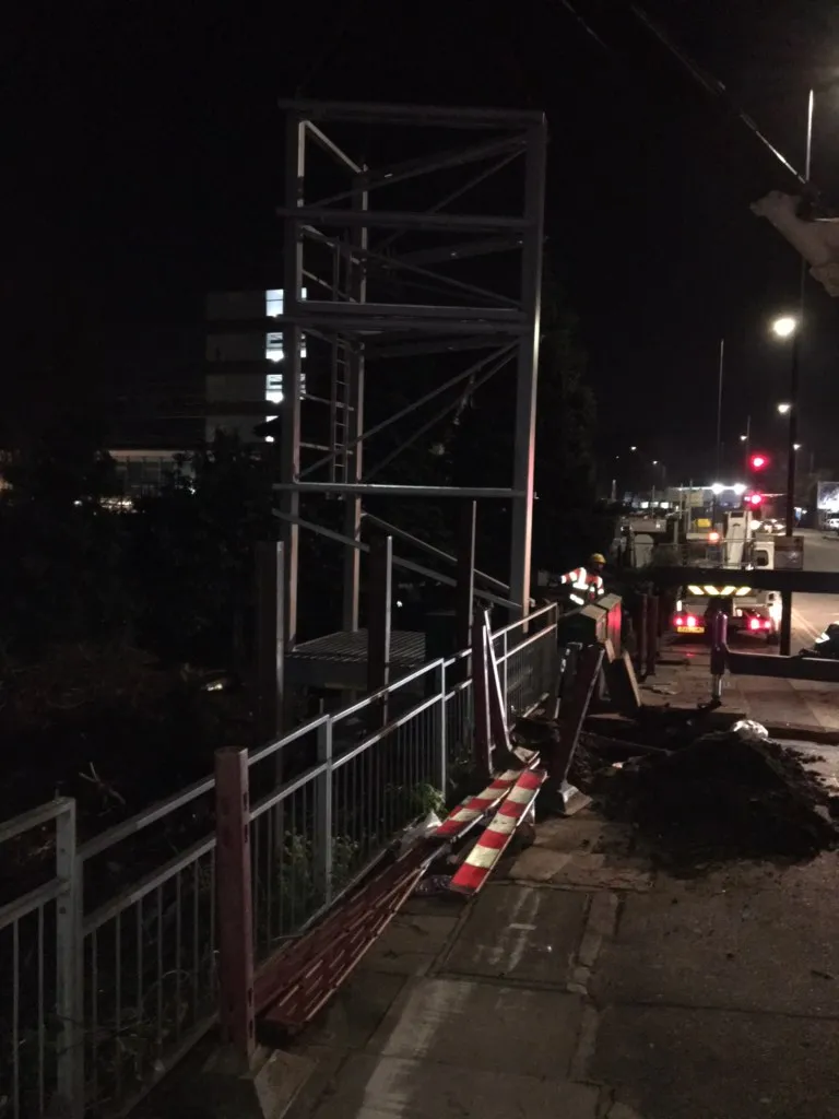 Nighttime engineering and installation work on a digital screen structure, representing DOOHable's hands-on development experience since founding