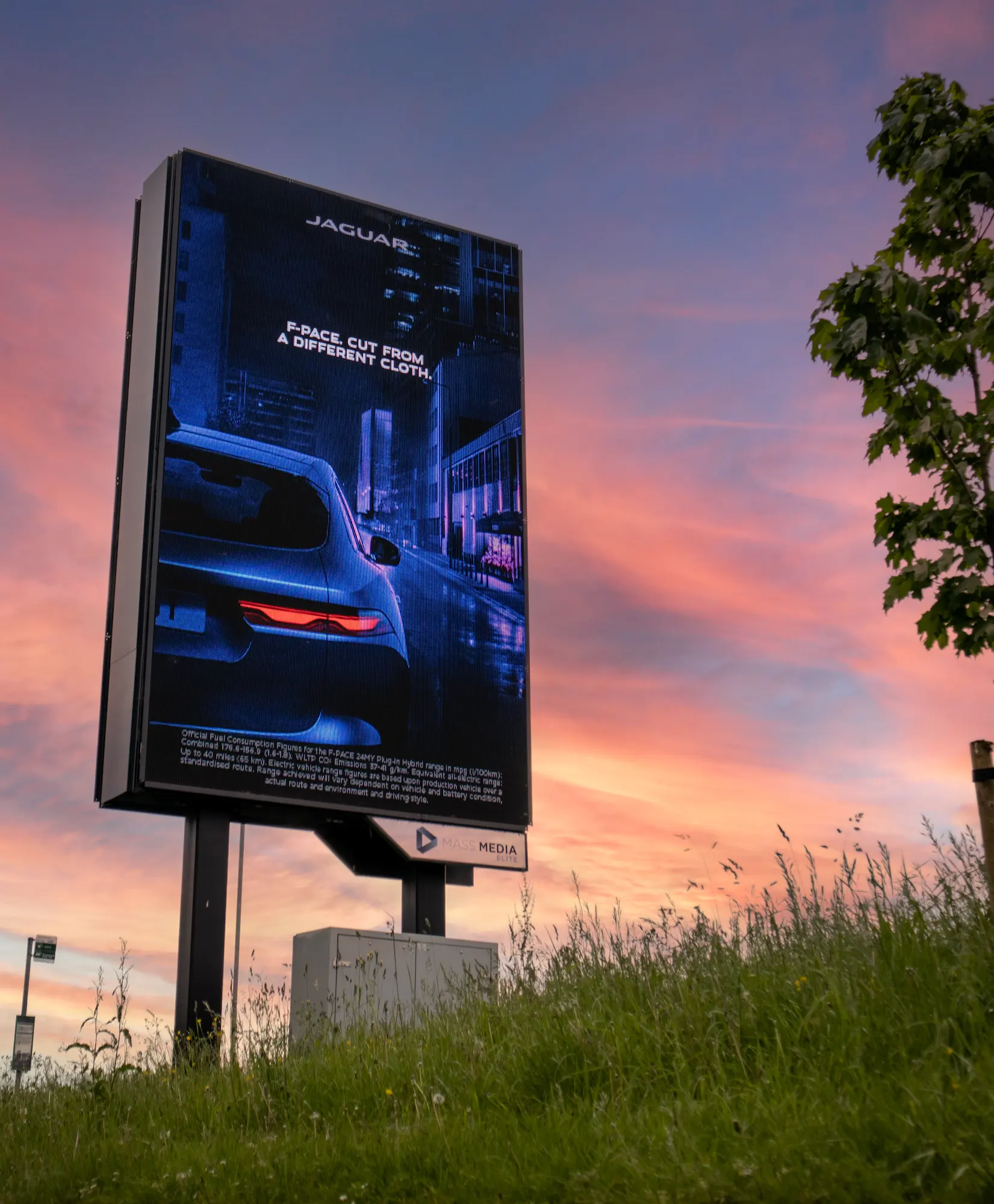 Digital billboard at sunset displaying a Jaguar campaign, the creative clearly visible against a dramatic sky