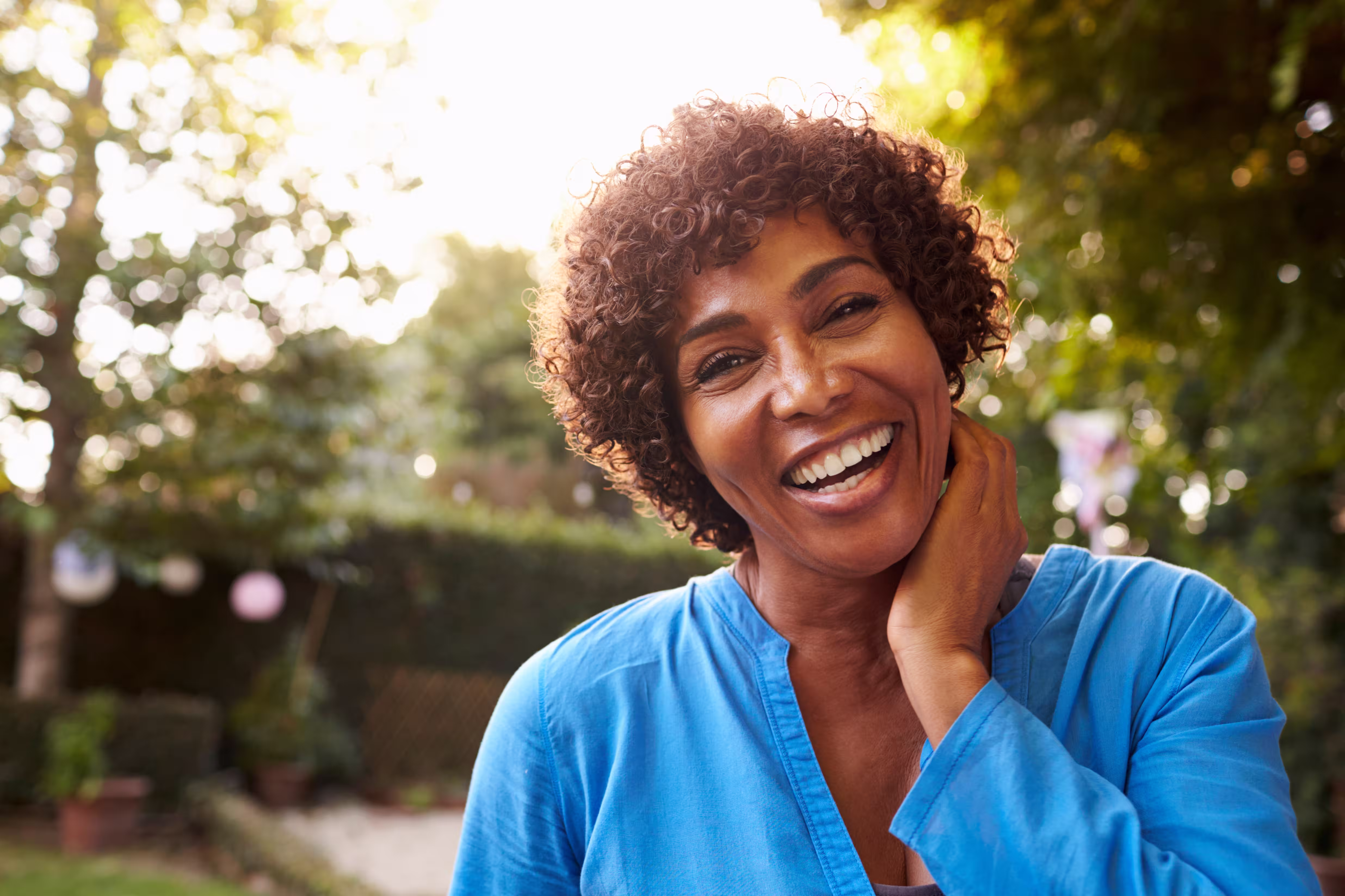 black woman in blue shirt smiling