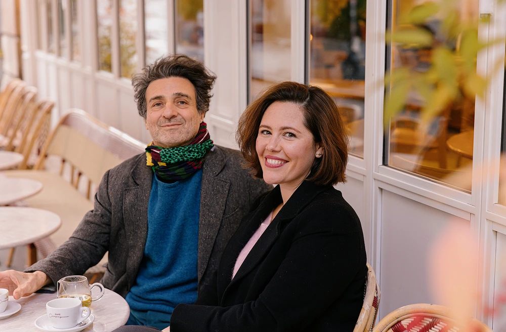Bertrand and Joana sat outside a Paris café