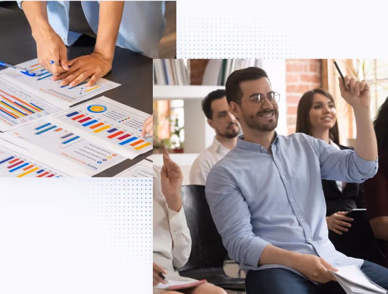 Man in glasses raising hand in a meeting with group and another person reviewing charts on a table.