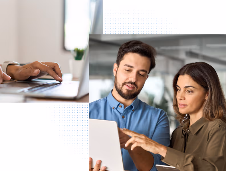 Two colleagues discussing work using a laptop and tablet in an office setting.