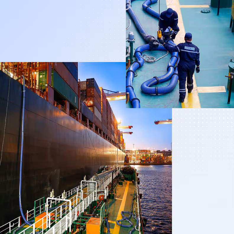 Two marine workers managing hoses on a ship deck beside a large container ship at dusk.