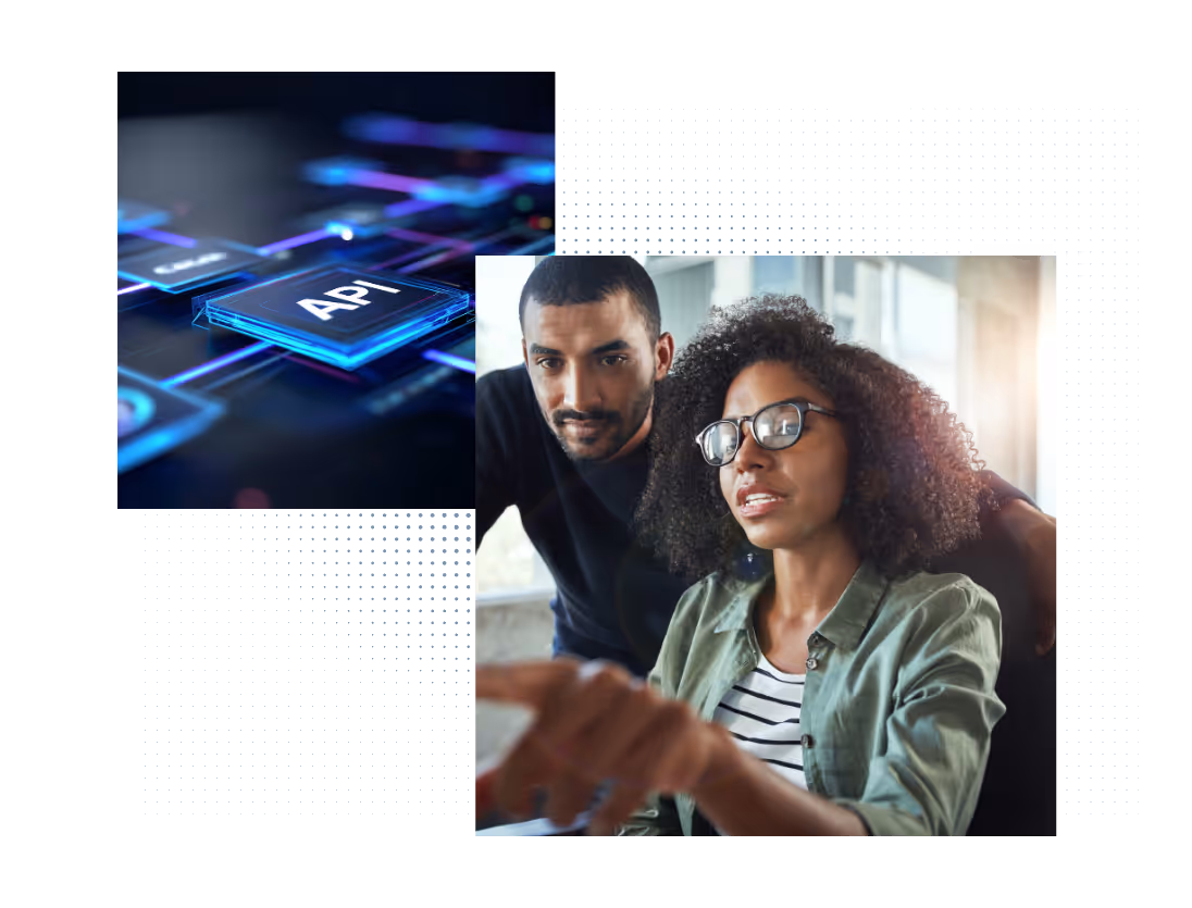 Two coworkers discussing at a computer with a futuristic digital API interface visual above them.