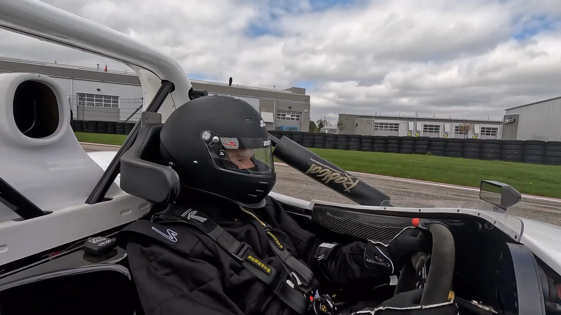 Driver sitting in a race car at M1 Concourse
