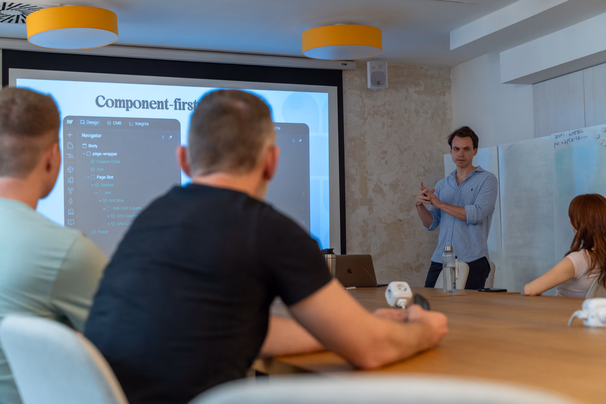 Nicholas presenting while people are listening to him.