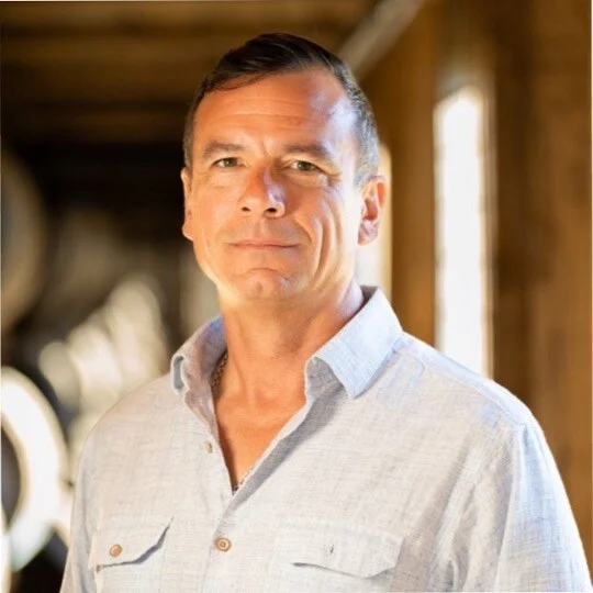 image of wine barrels in a winery cellar