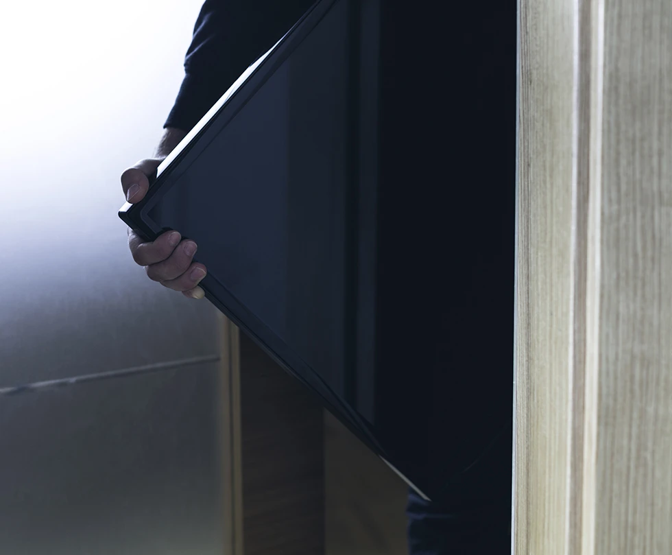 A thief stealing TVs