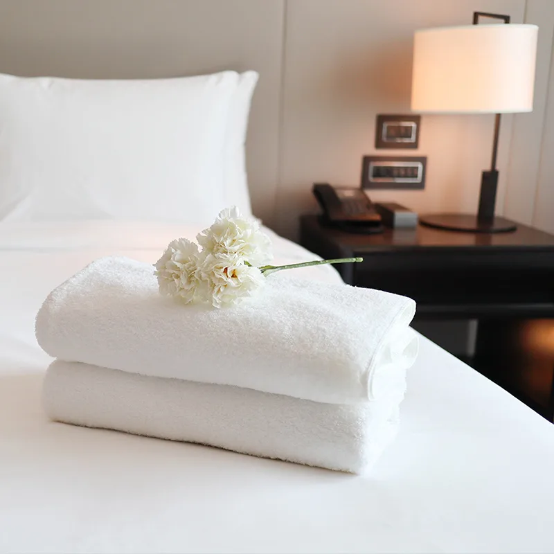 A flower placed on a stack of hotels at a rental.