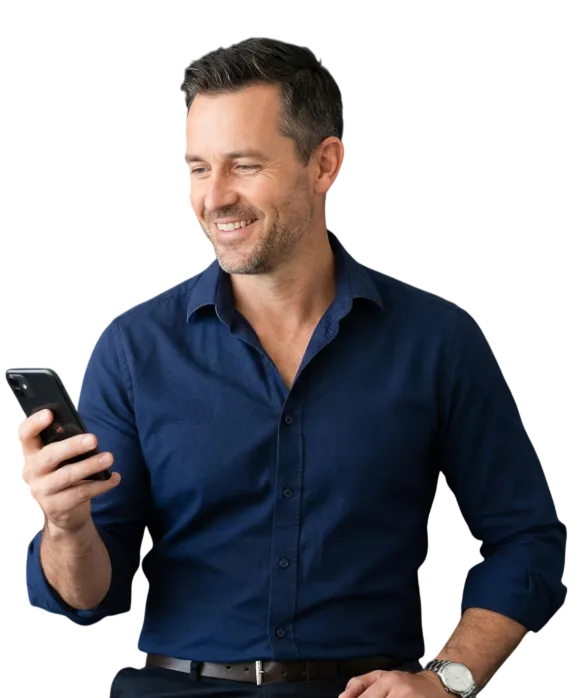 Smiling man in a blue shirt looking at his smartphone.