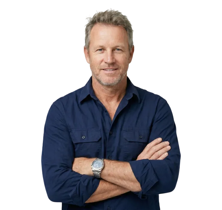 Middle-aged man with gray hair and beard wearing a navy blue shirt and a wristwatch, arms crossed and smiling.