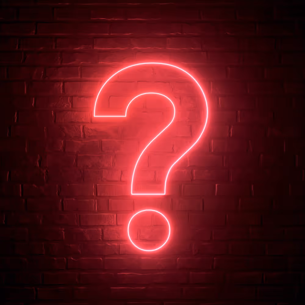 Silhouettes of tall buildings and a large Ferris wheel against a vibrant orange sunset sun.