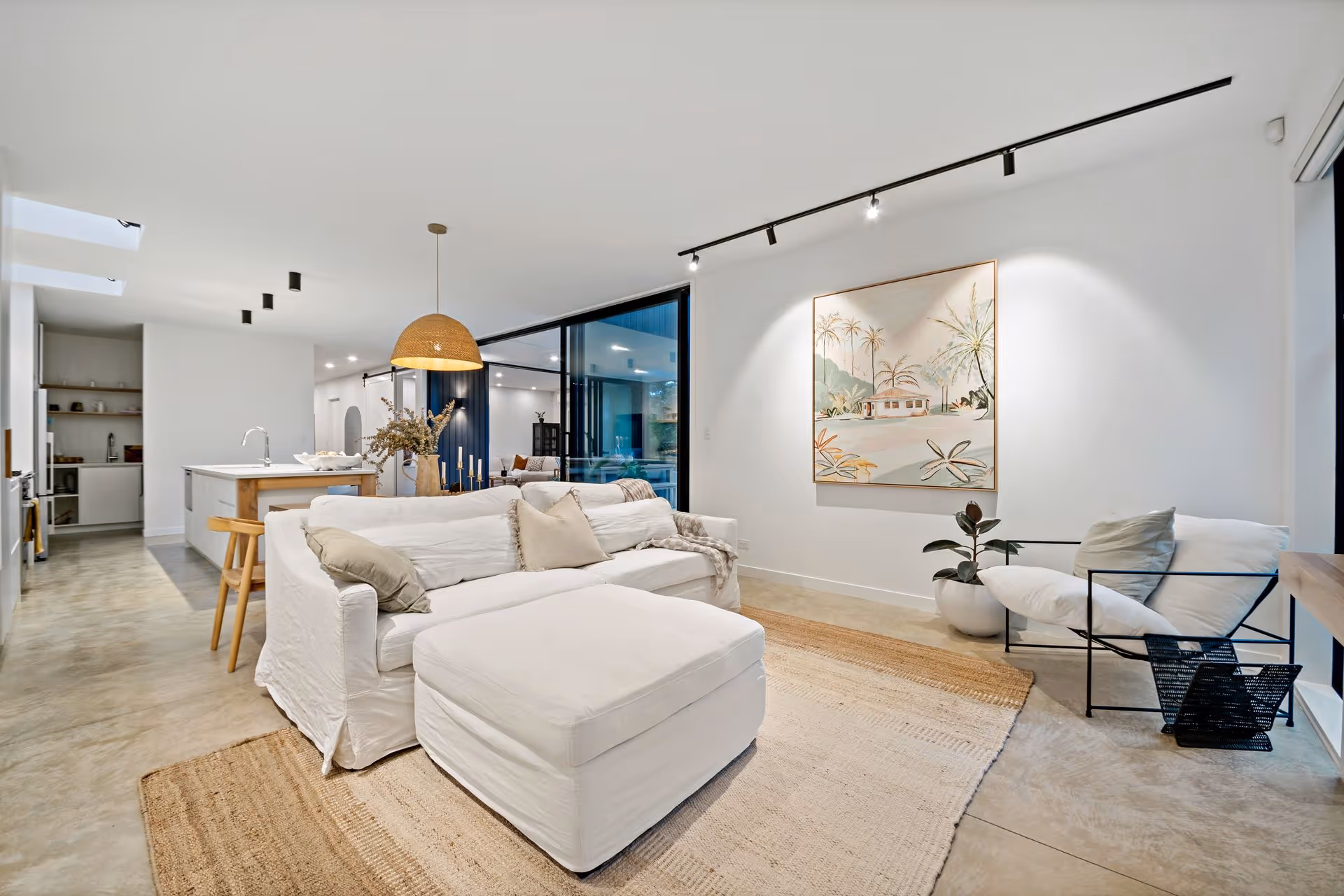 Partially constructed wooden deck attached to a white house with power tools and a hammer on newly installed white boards.