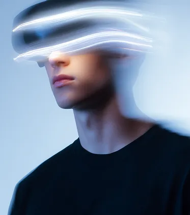 Young man wearing a virtual reality headset with motion blur and light trails around the device.
