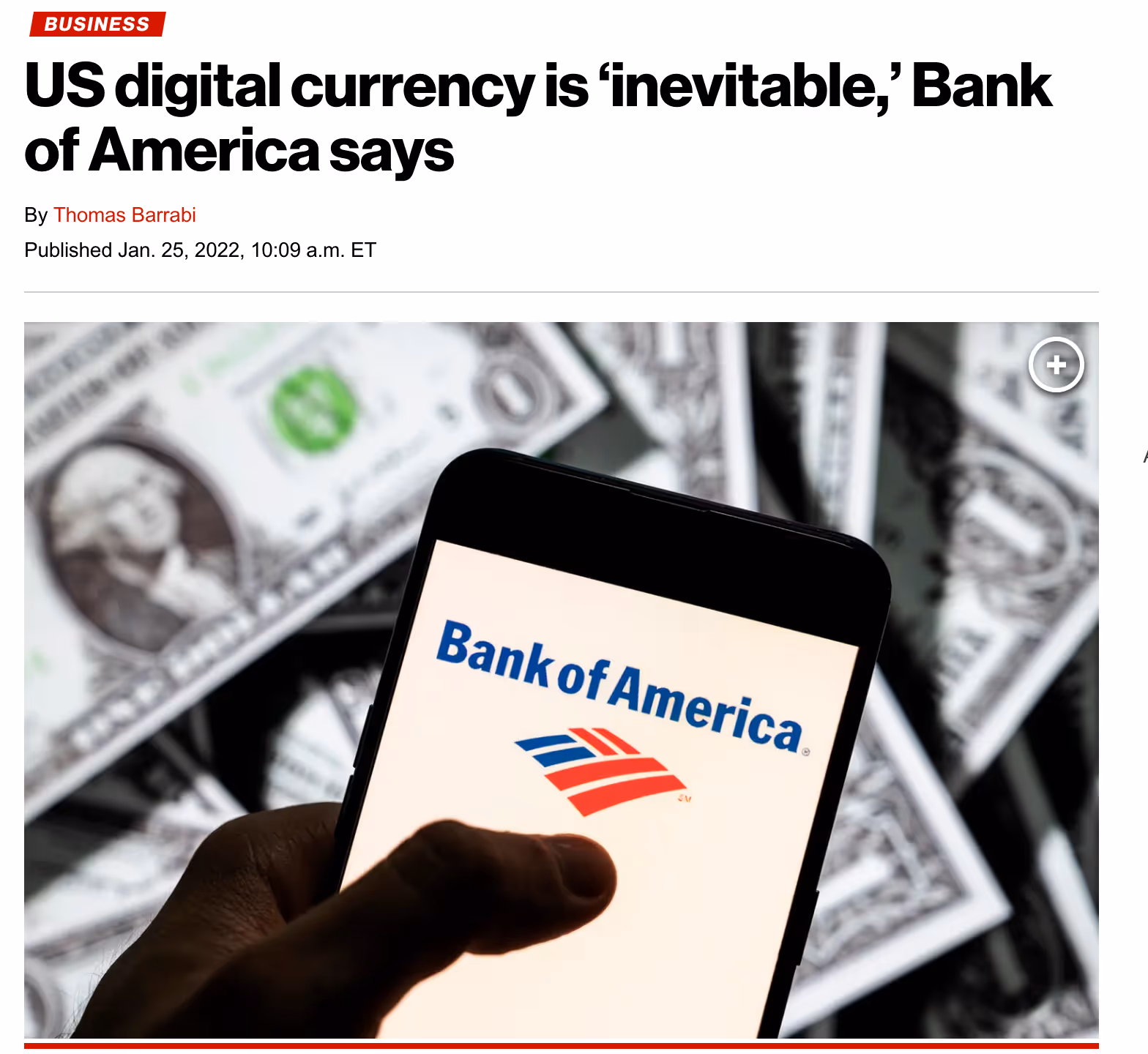 Hand holding smartphone displaying Bank of America logo over scattered US dollar bills.