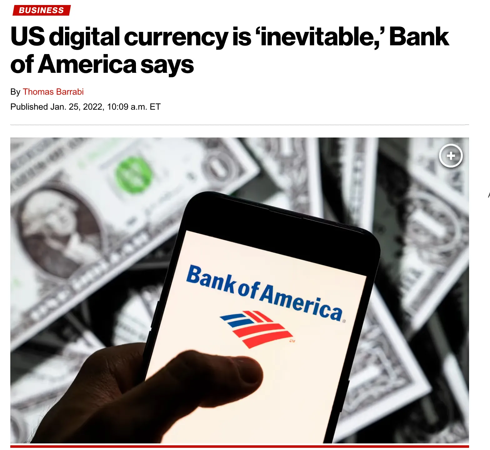 Hand holding smartphone displaying Bank of America logo with US dollar bills in background.