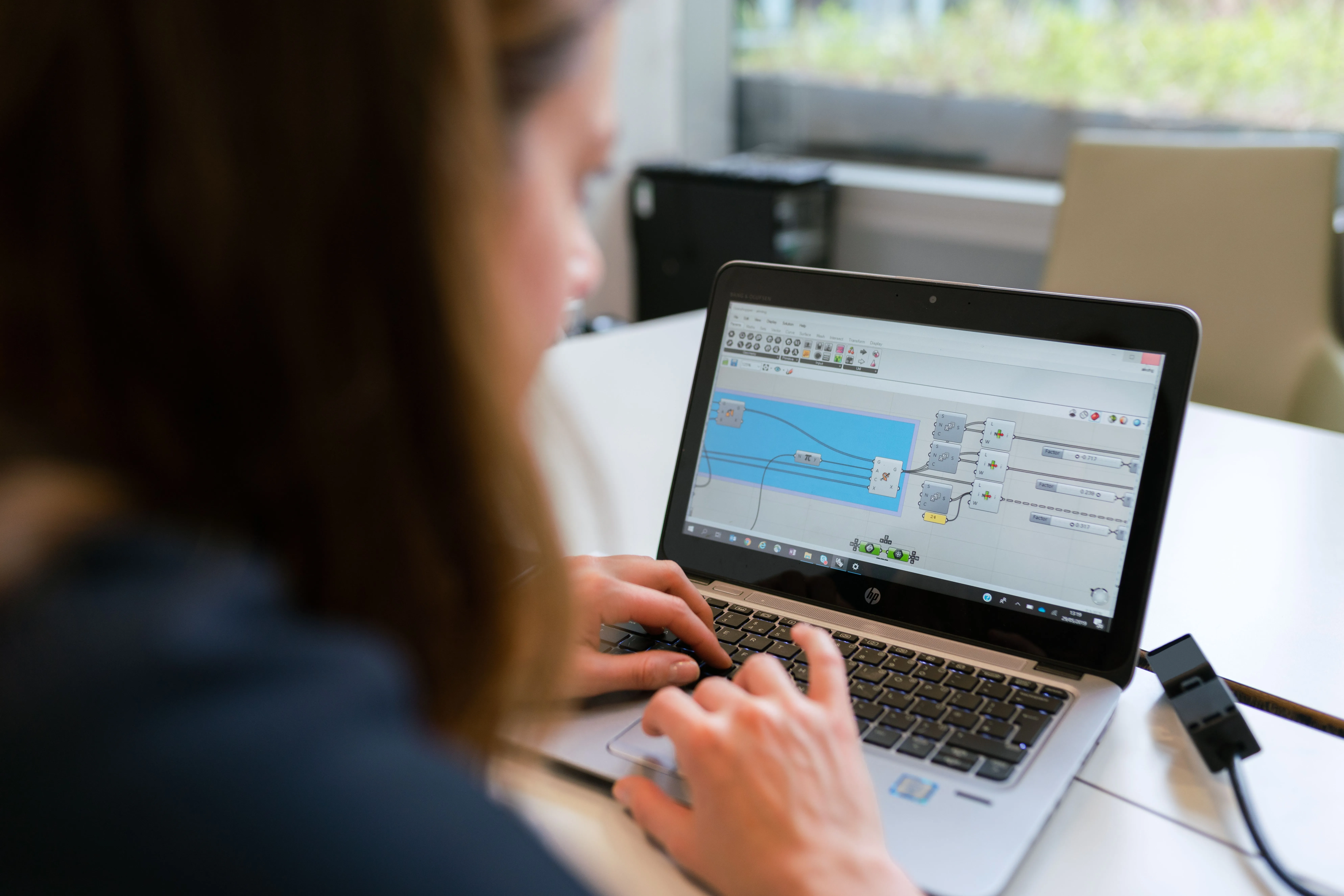 A developer configuring custom visual data workflows on a laptop screen, illustrating backend system integration or automated analysis tools for h3zoom.ai.
