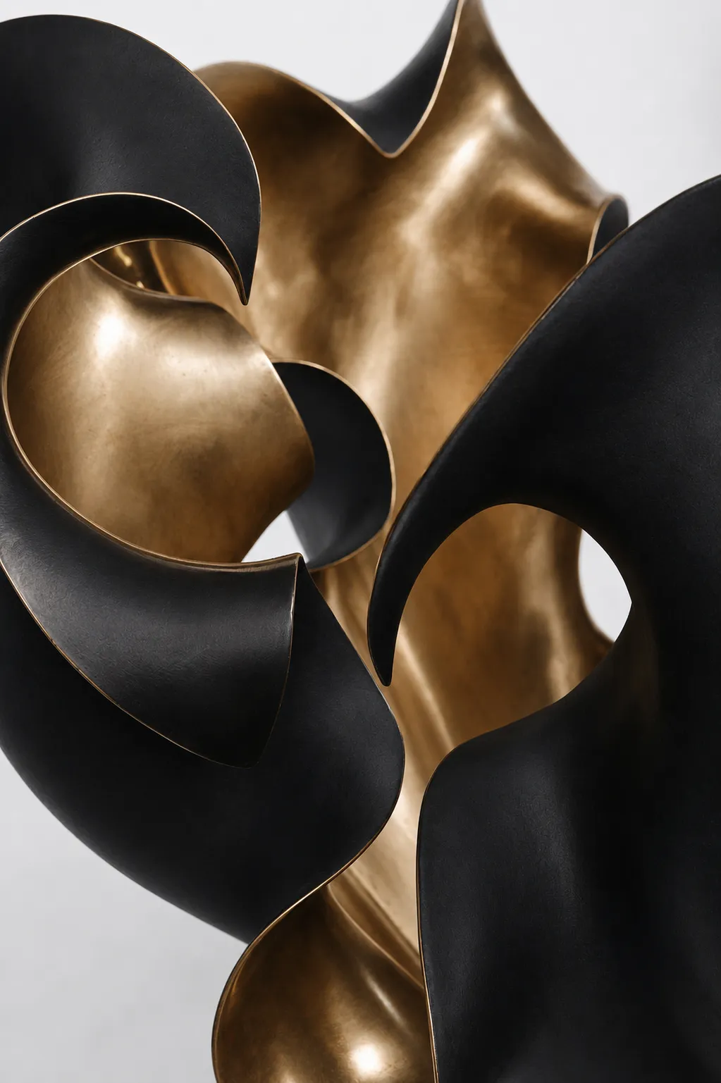 Close-up of the black and polished bronze surfaces of Petalum V Large.