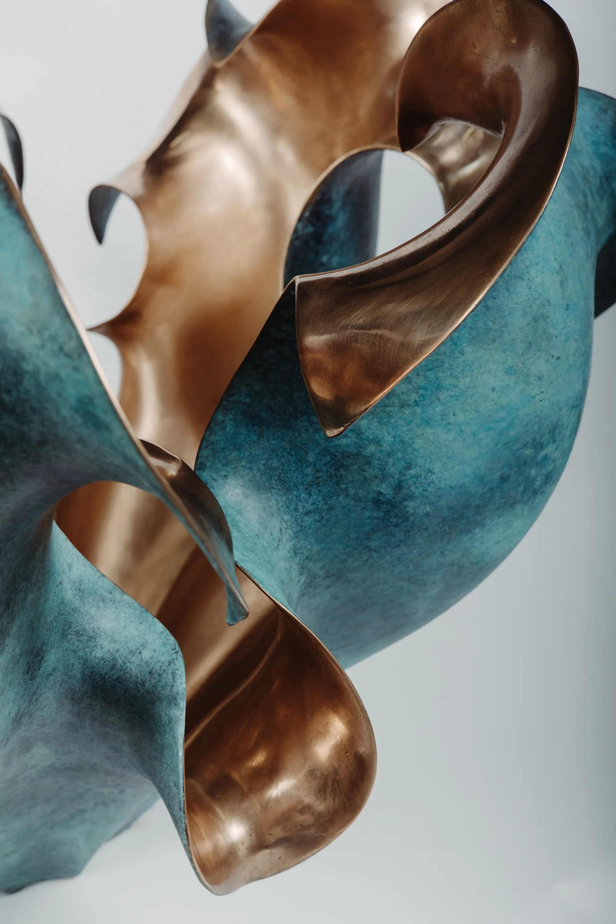 Close-up of the turquoise patina and polished bronze details of Petalum V Medium.