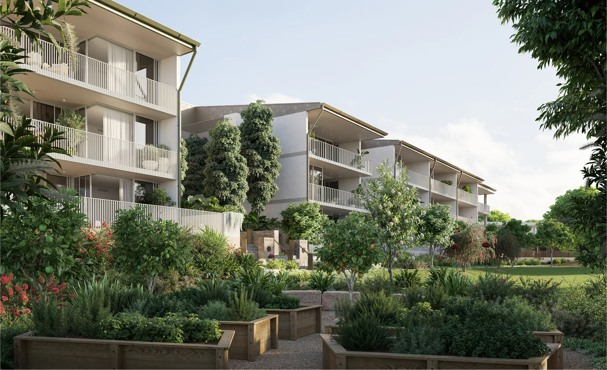 Modern low-rise apartments with balconies surrounded by lush garden featuring fruit trees and raised planter beds.