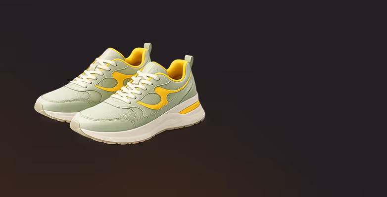 Pair of light green and yellow sneakers with white soles on a dark background.
