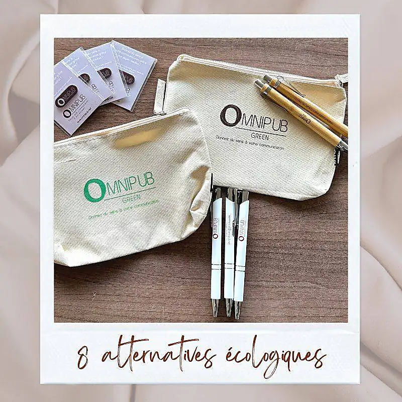 Deux trousses écologiques Omnipub Green avec stylos et cartes de visite sur une surface en bois.