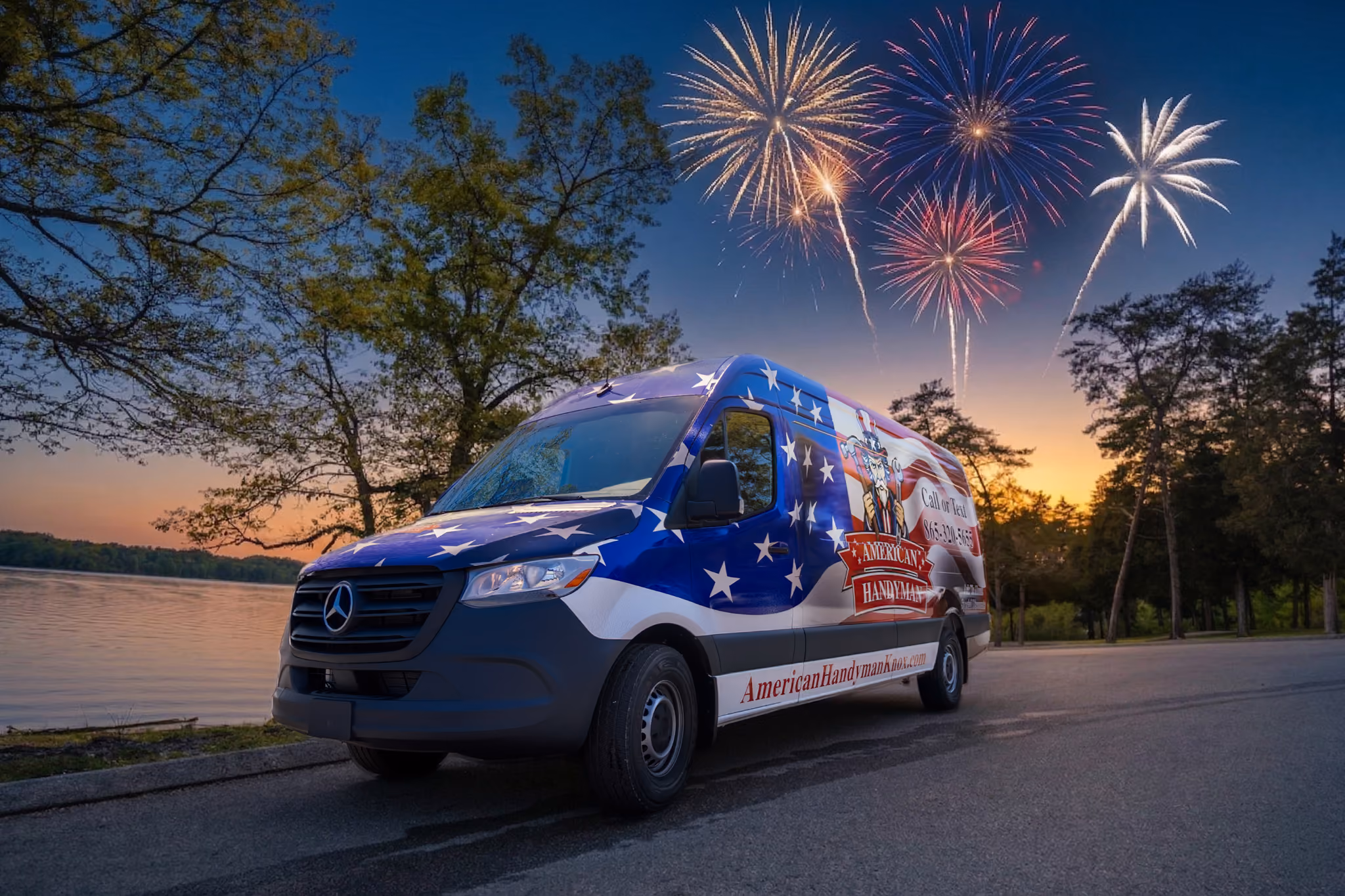 Mercedes van wrapped in an American flag design parked by a lakeside at sunset with fireworks in the sky.