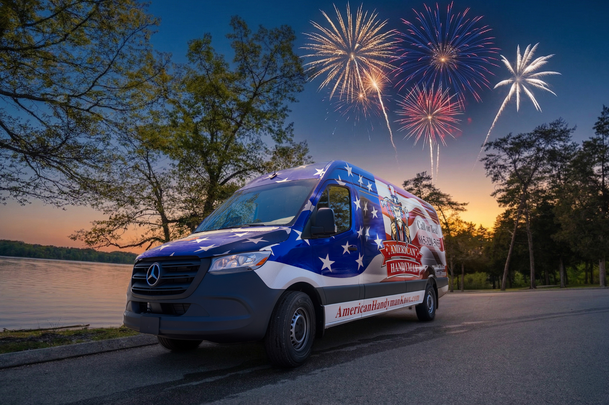 Mercedes van wrapped in an American flag design parked by a lakeside at sunset with fireworks in the sky.