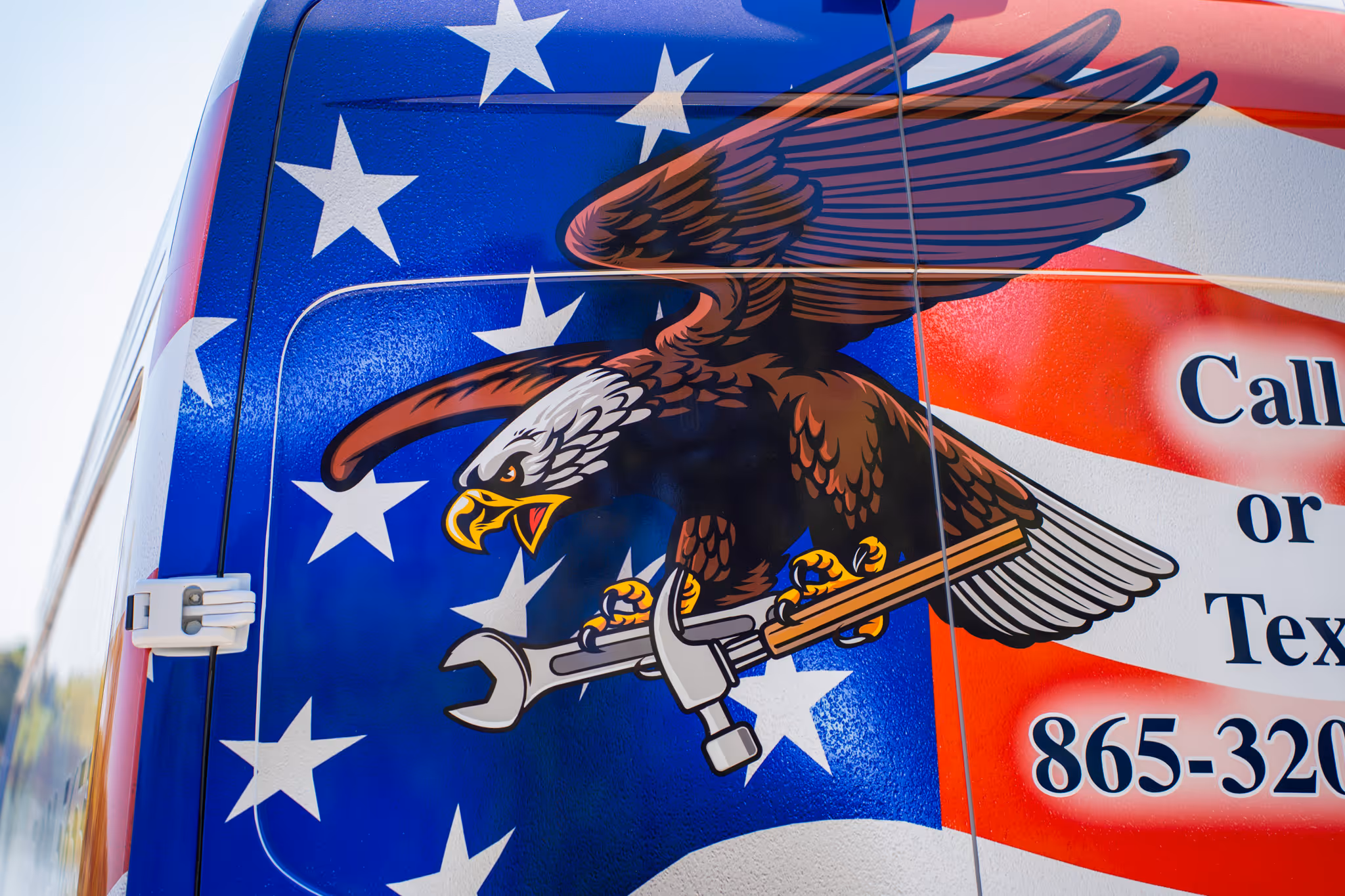 Illustration of a bald eagle clutching a wrench and hammer on an American flag background.
