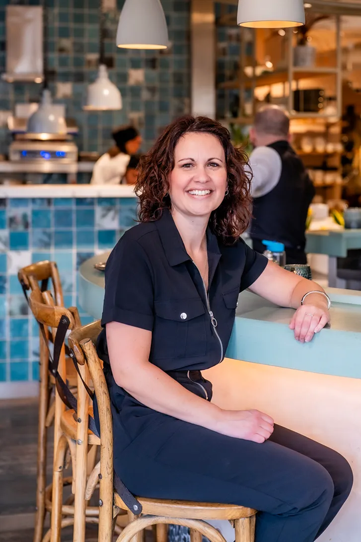 An image of Davina sat at a bar.