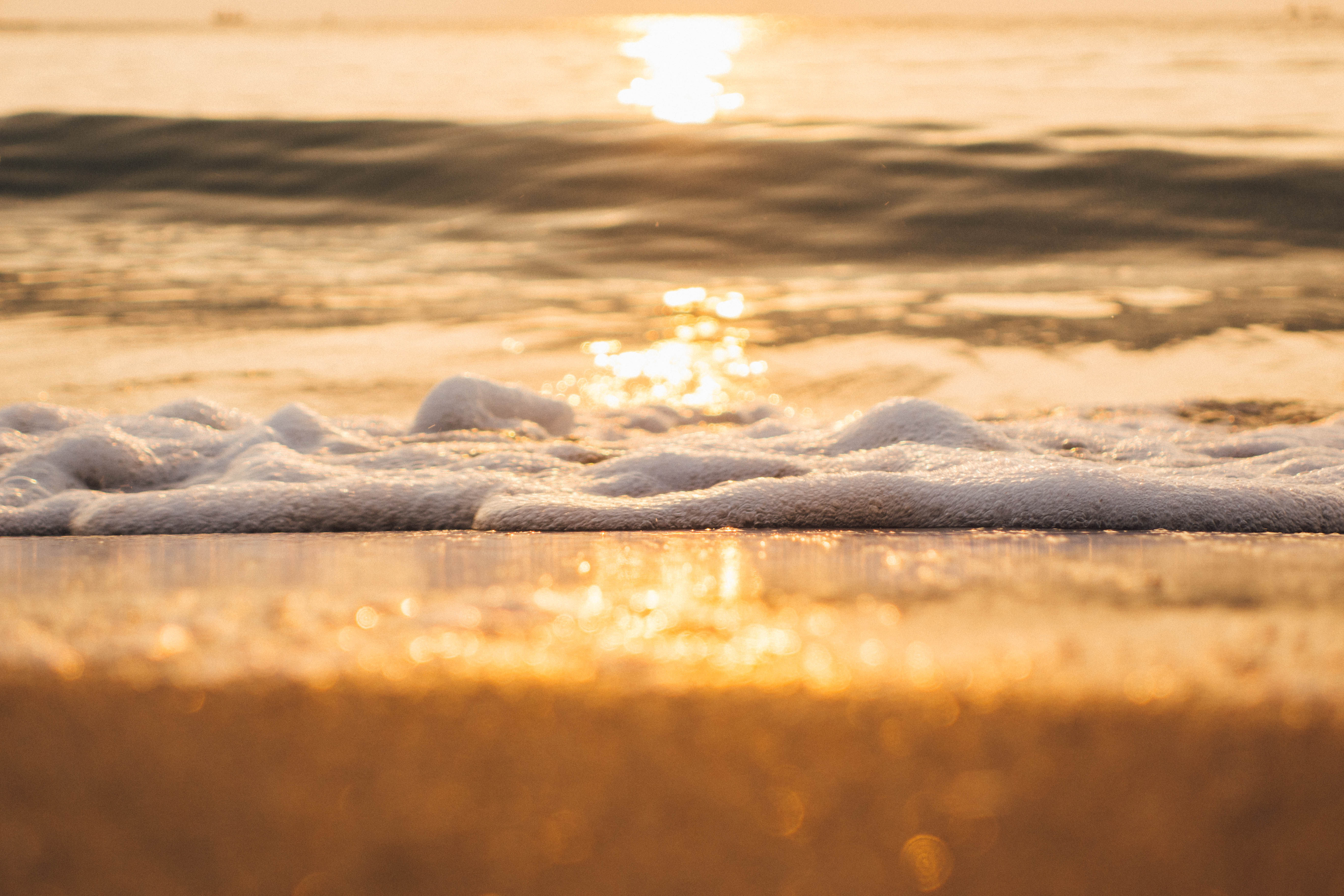 Soft golden sea waves at sunrise