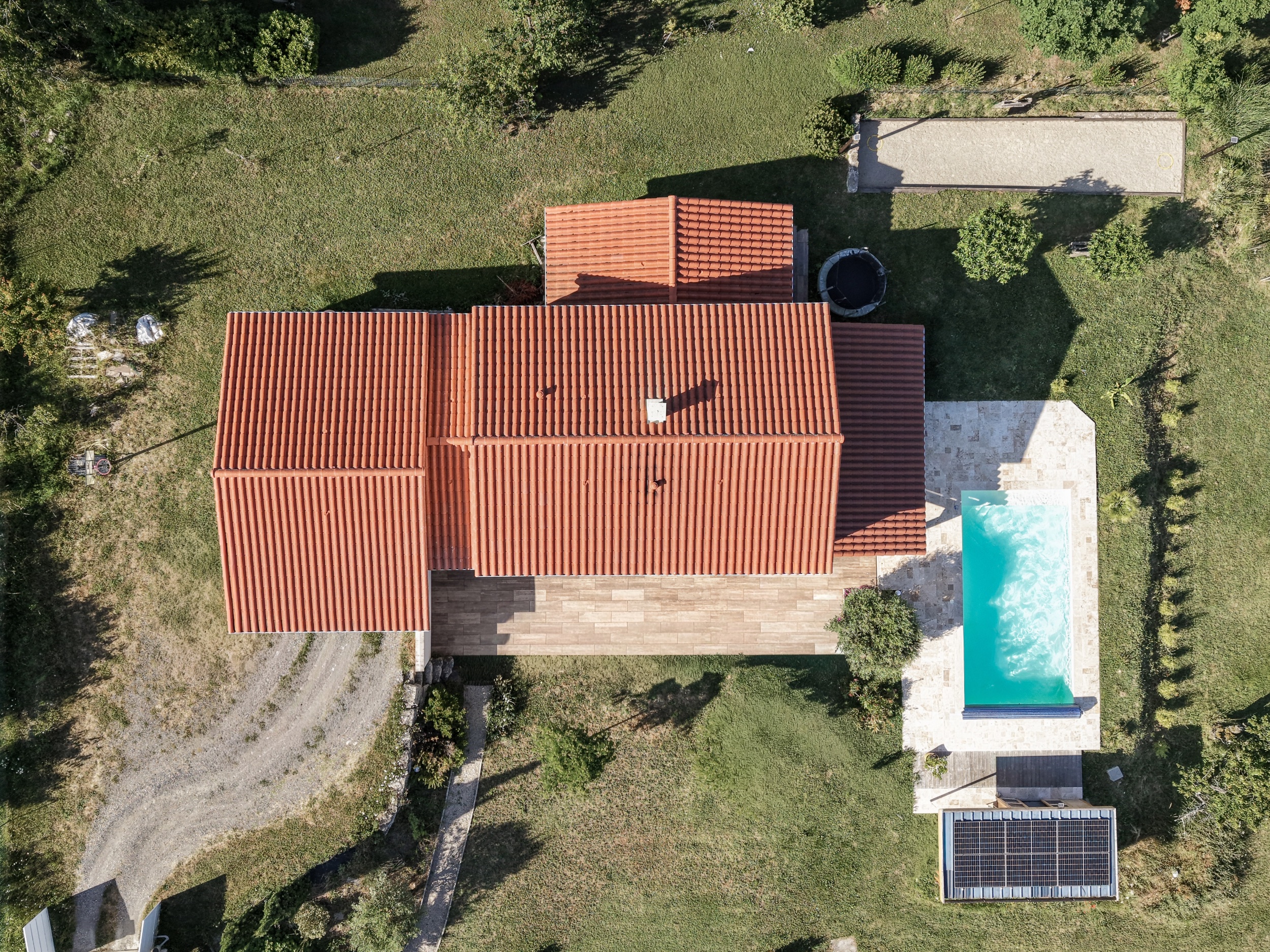 Vue aérienne verticale de la maison et de ses aménagements extérieurs.