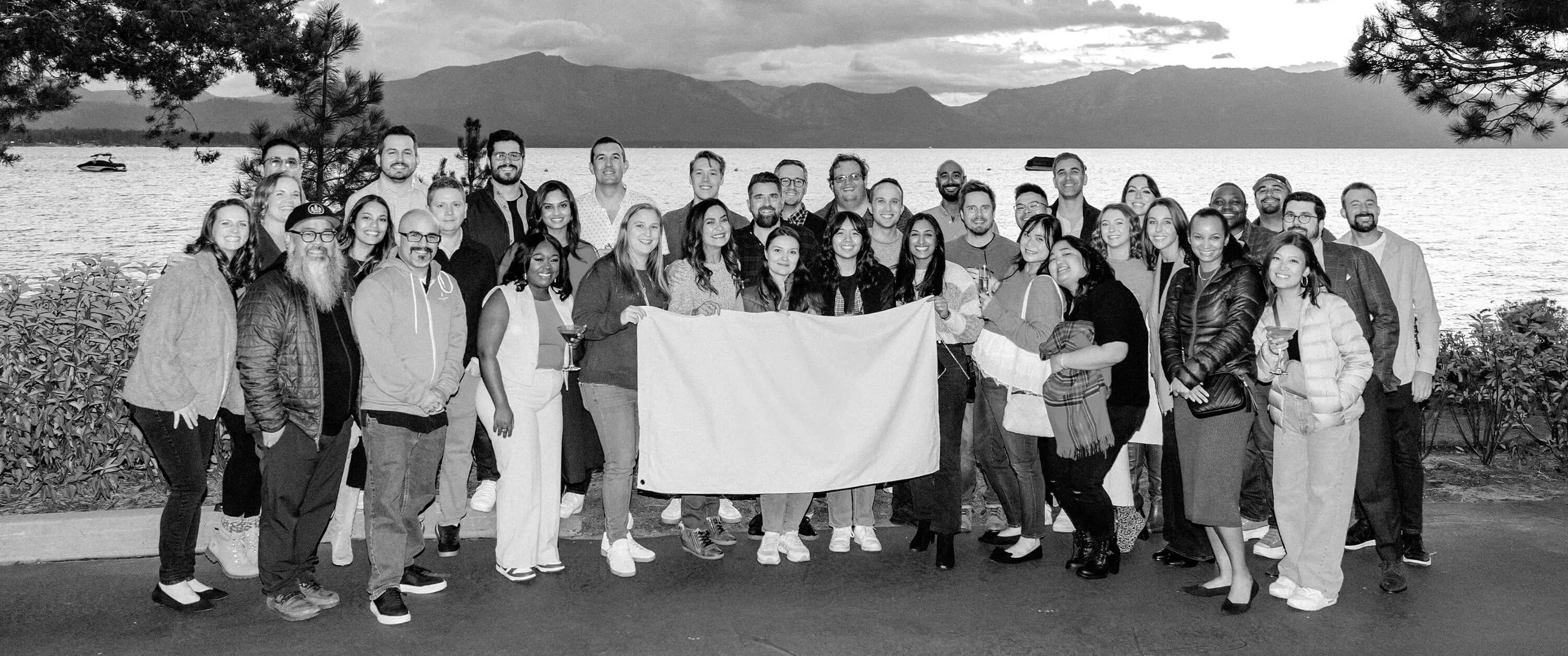 Black-and-white group photo of the Five & Done team with 40+ team members.