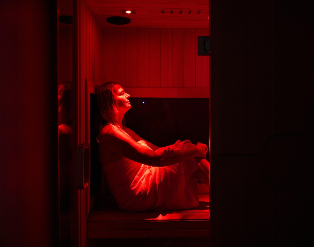 woman sitting in infrared sauna
