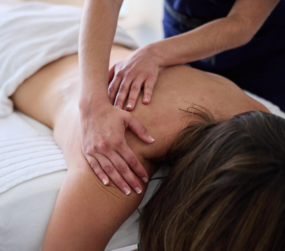 massage therapist with female patient at restore and revive