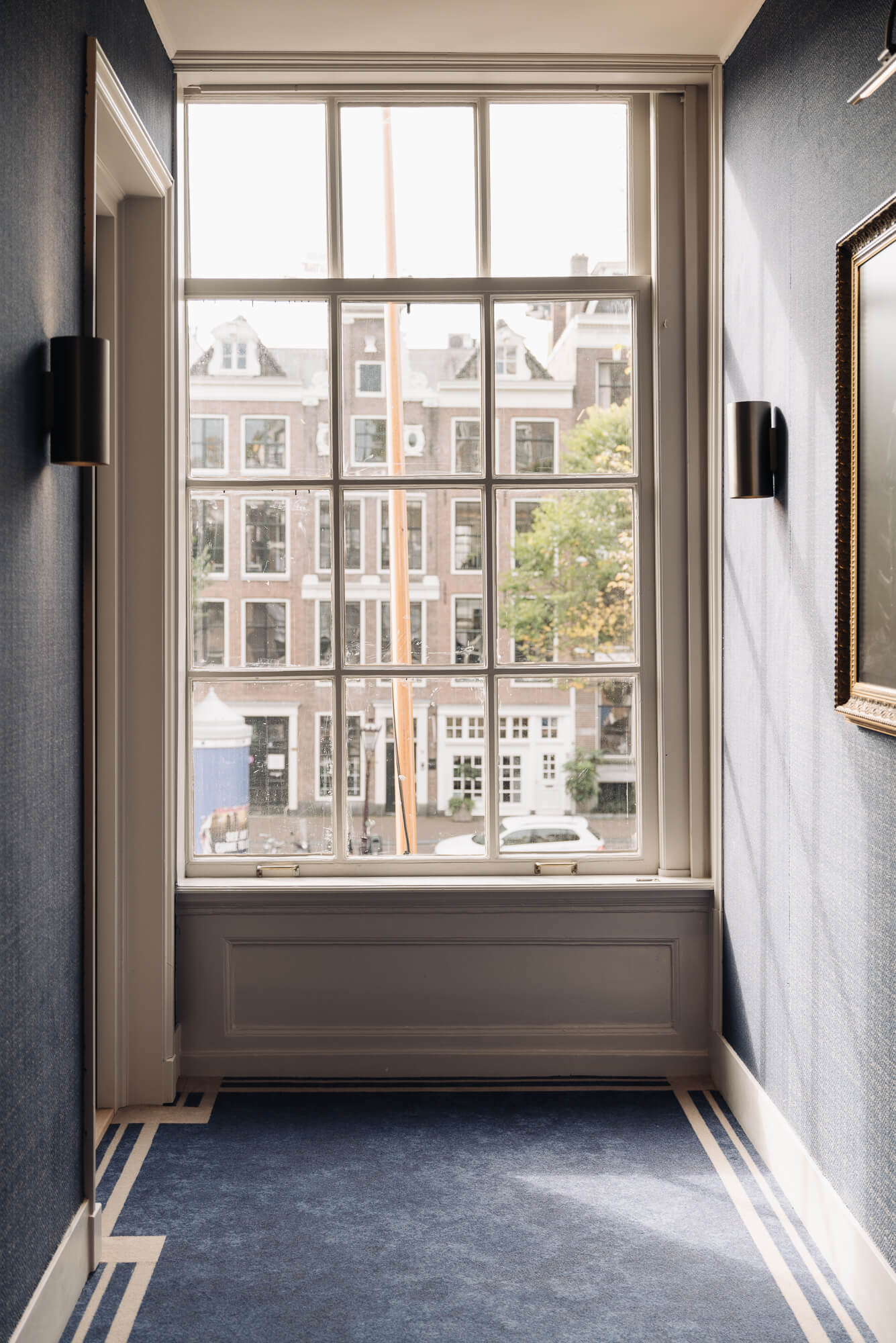 Hotel 717 interior design in Amsterdam with classic window and canal view by HIP Studio