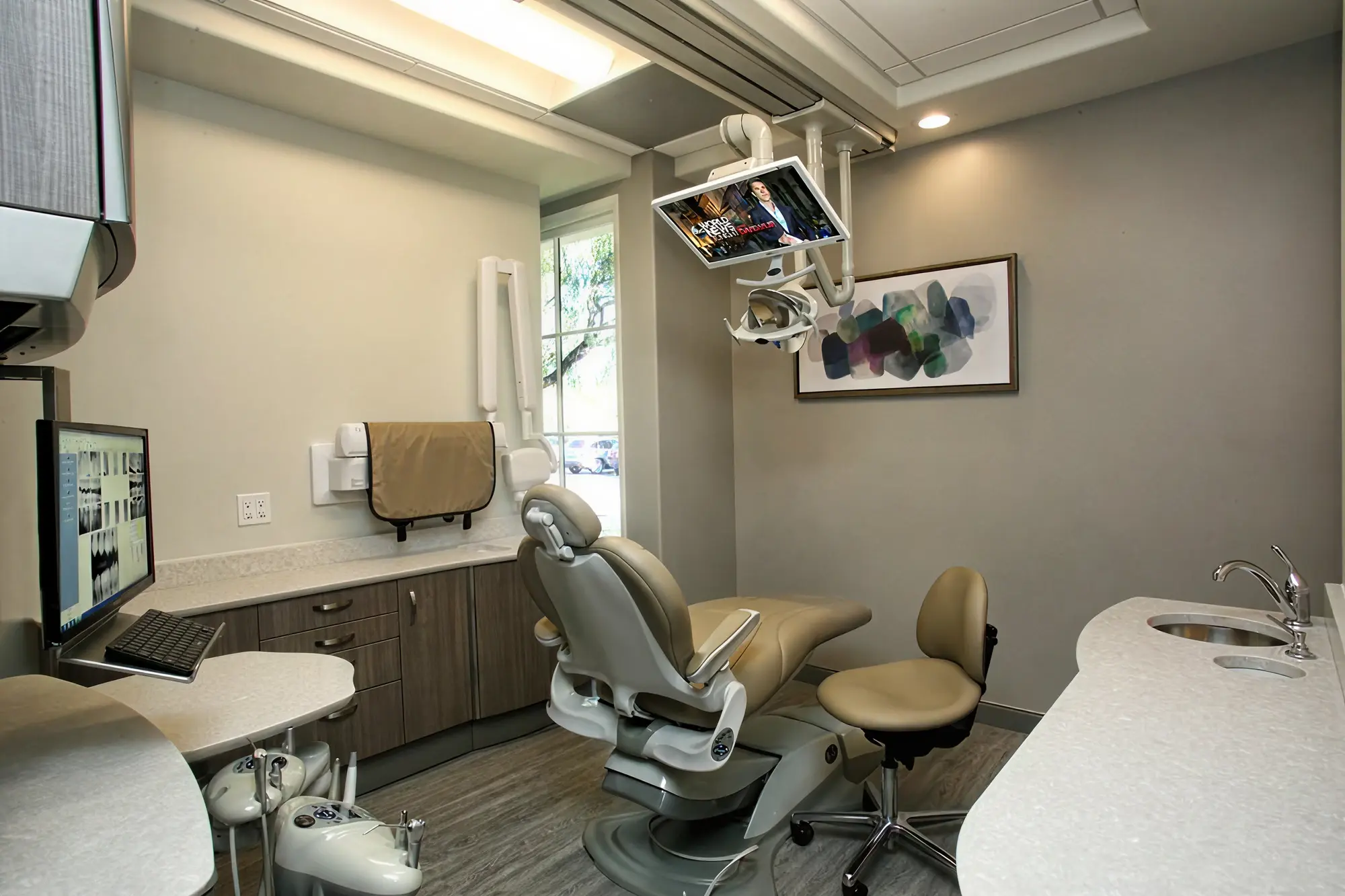 Dental operatory at Ortega Cottage Dentistry with patient chair, overhead monitor, and digital X-ray display