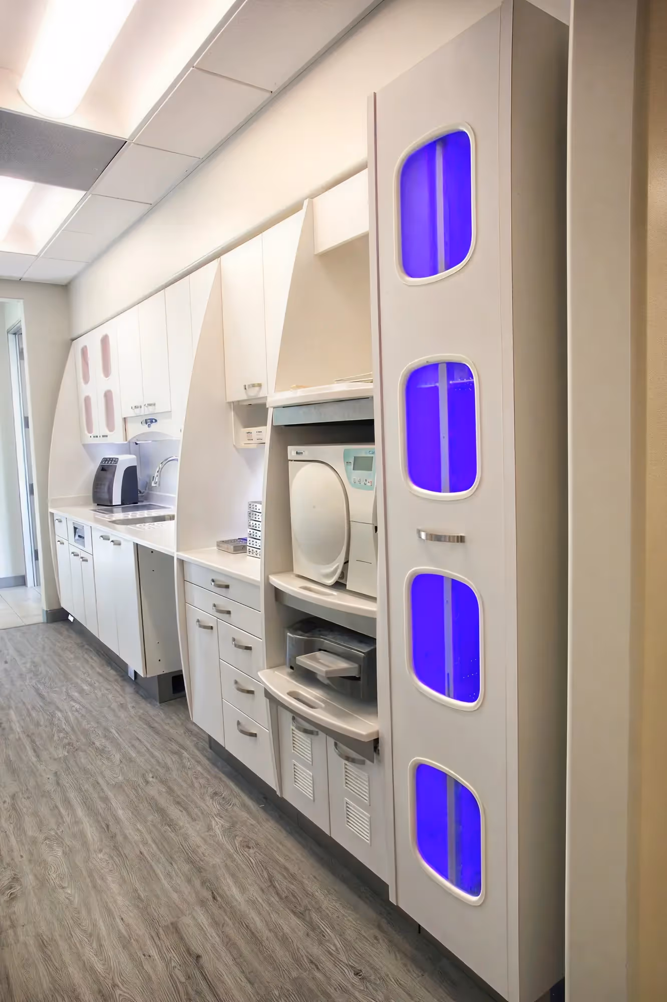 Sterilization tower with blue UV lighting and autoclave equipment at Ortega Cottage Dentistry