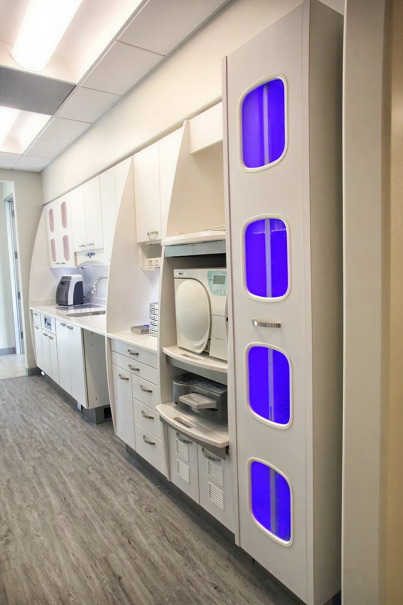 Sterilization tower with blue UV lighting and autoclave equipment at Ortega Cottage Dentistry