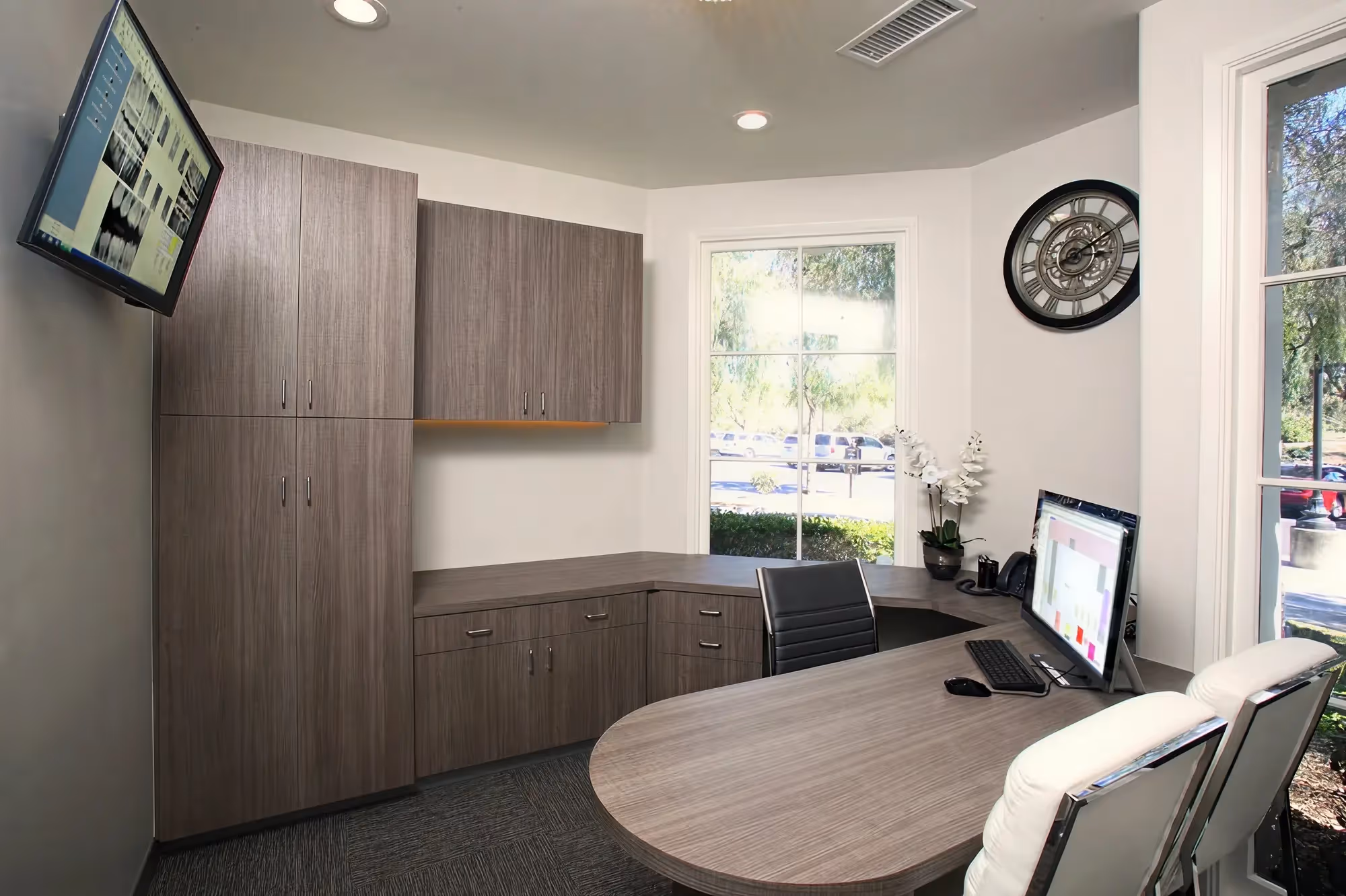 Private treatment planning office at Ortega Cottage Dentistry with dental X-ray display and curved consultation desk