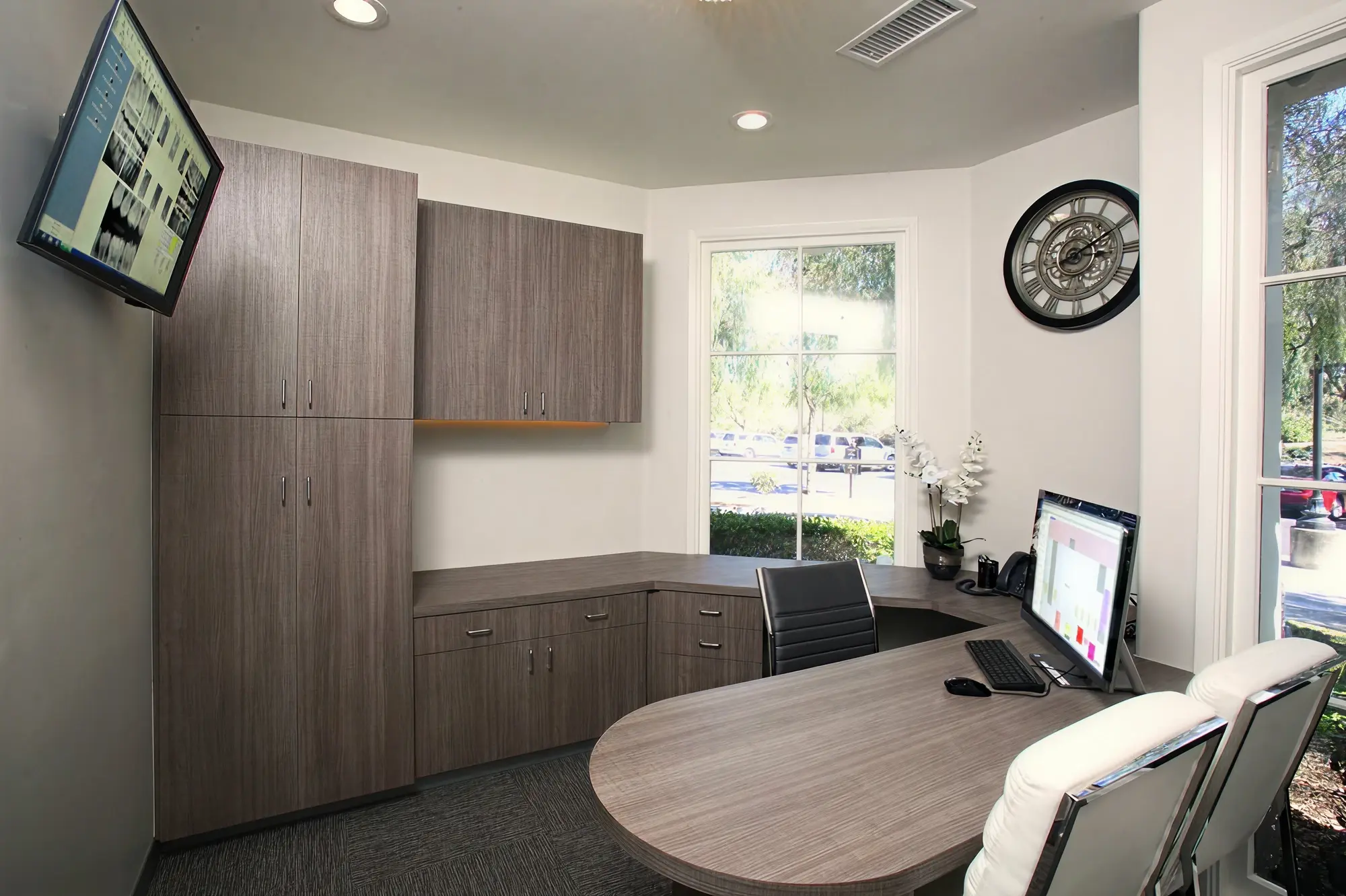 Private treatment planning office at Ortega Cottage Dentistry with dental X-ray display and curved consultation desk