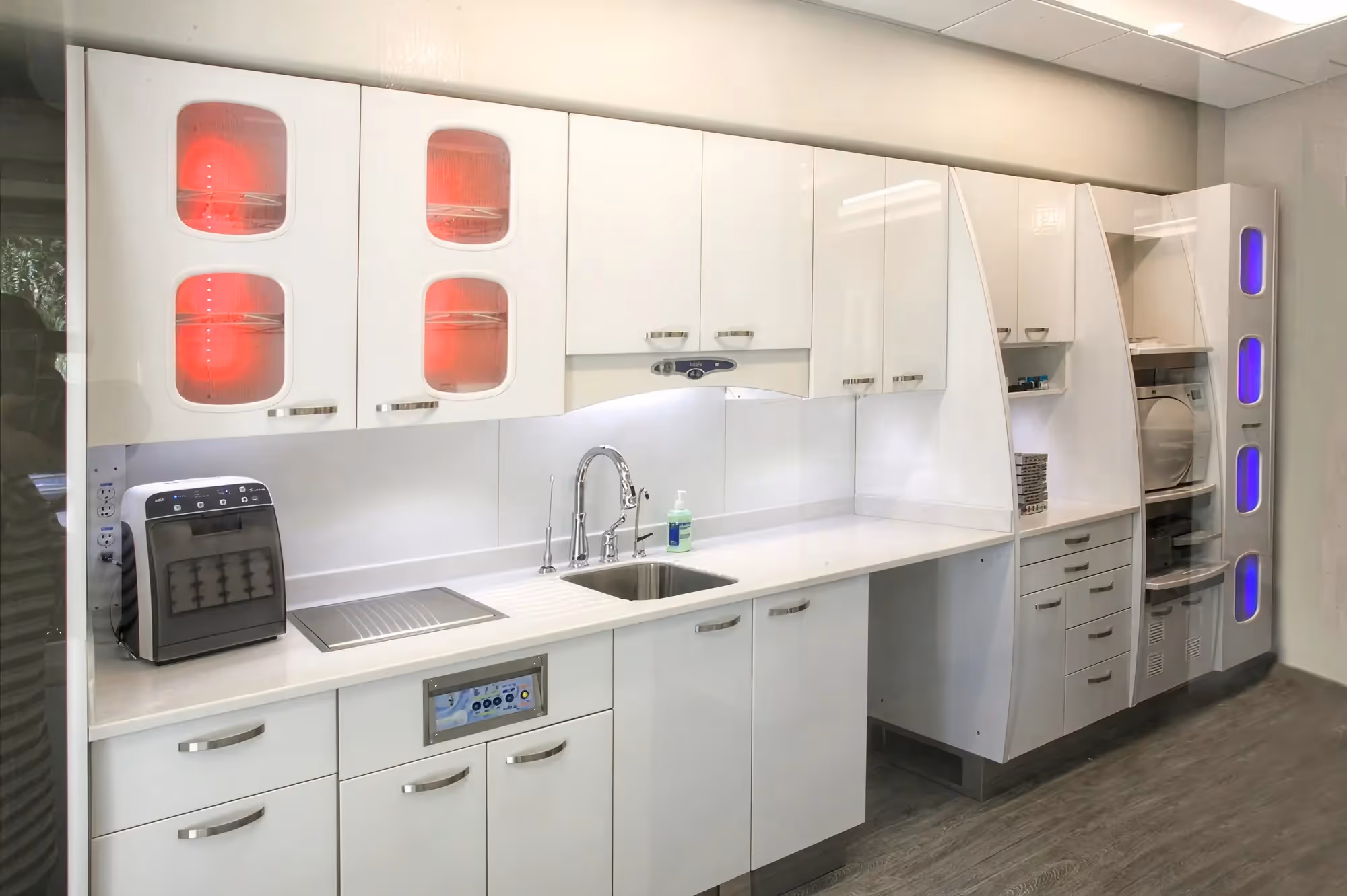 Sterilization and instrument processing area at Ortega Cottage Dentistry with UV sterilization units and white cabinetry