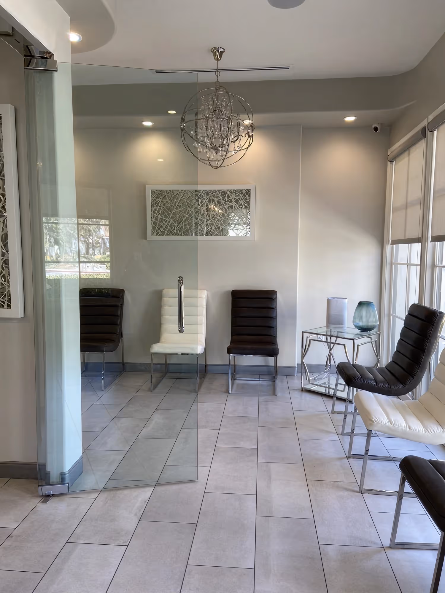 Modern patient waiting area at Ortega Cottage Dentistry with globe chandelier and contemporary seating