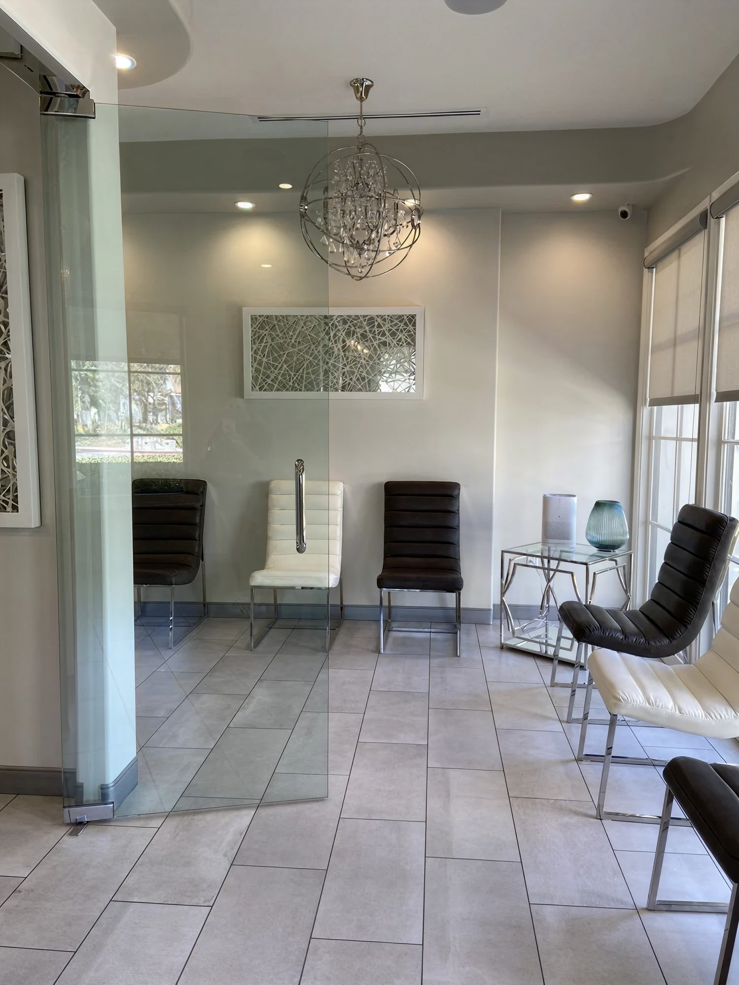 Modern patient waiting area at Ortega Cottage Dentistry with globe chandelier and contemporary seating