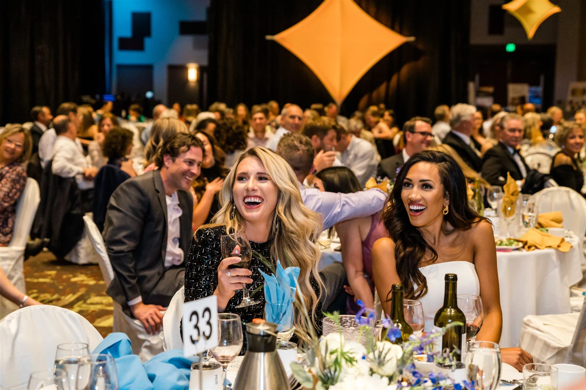 Guests laughing together at their table during the Unite for Hope Gala in Boise