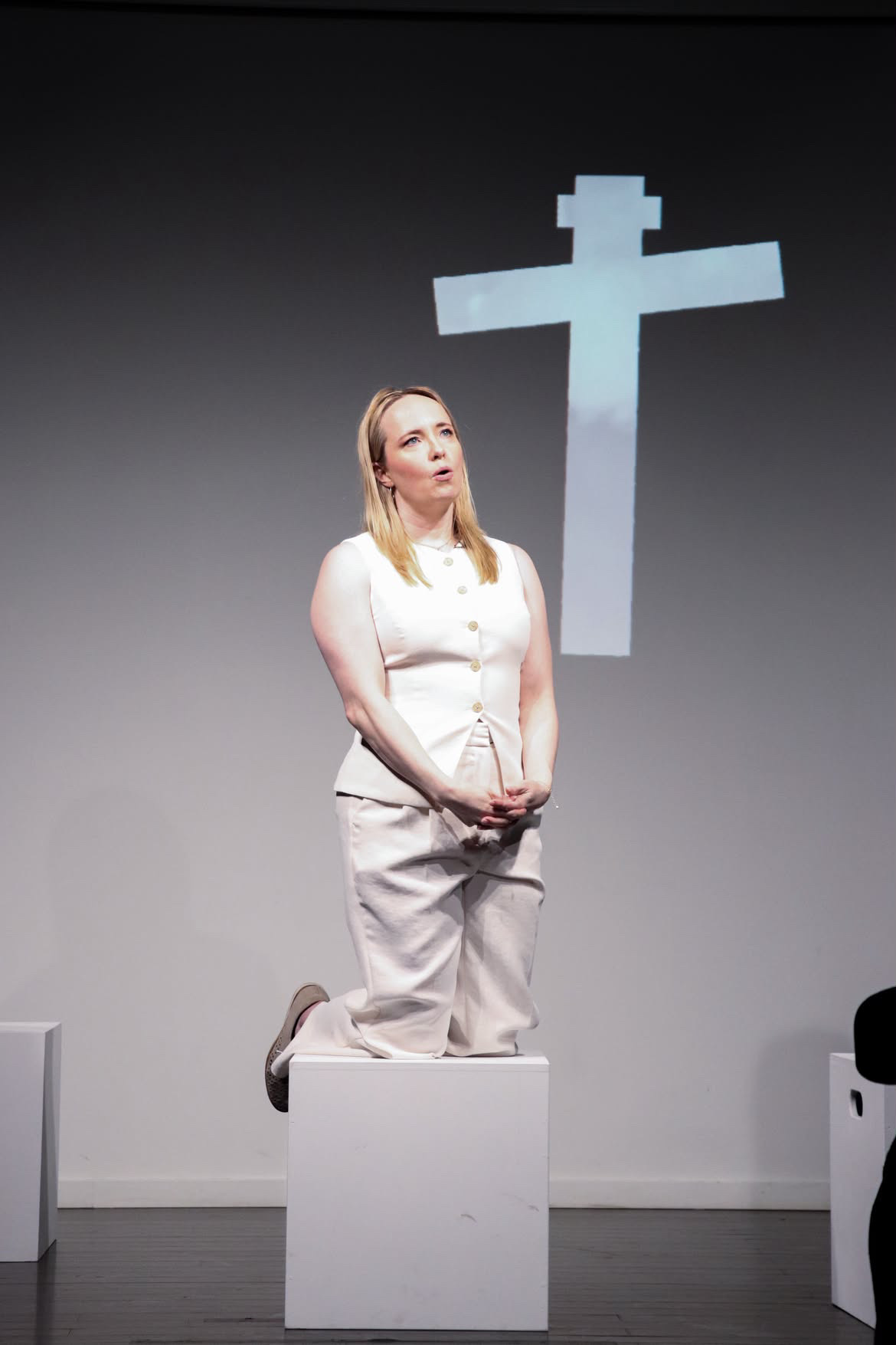 Simple staging — one chair, projections — for Gada Jane’s Becoming Psychic, Montréal Fringe 2026.