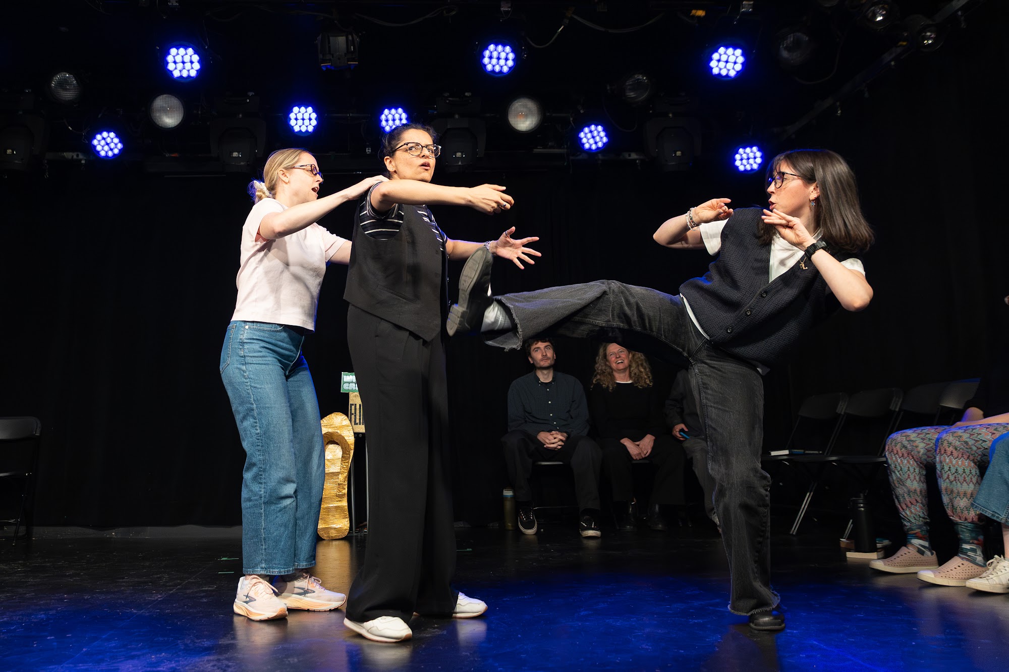 Three improvisers on stage in Flip Flop at Petit Campus, Montréal Fringe 2026.